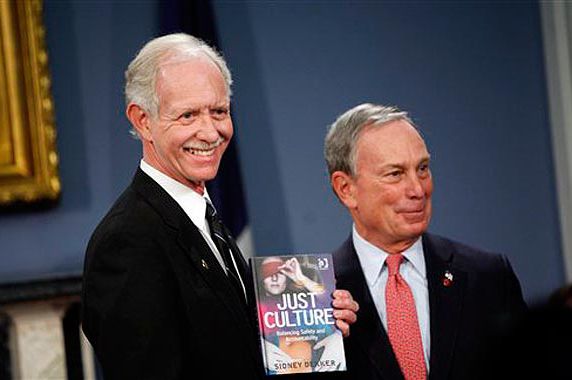 Mayor Bloomberg gives Sully a copy of the book the pilot lost on Flight 1549.